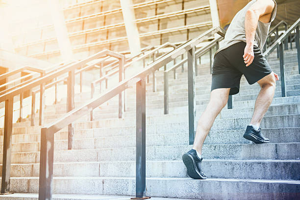 istock Athletic man going to stadium up the stairs 614975528