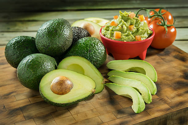 Avocados and tomatoes on a cutting board