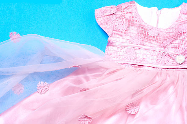 istock Clothes for baby girl on a pink background. Copy space 614979664