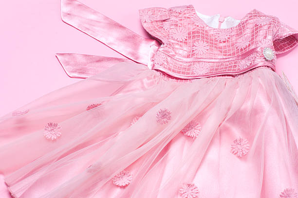 istock Clothes for baby girl on a pink background. Copy space 614979774