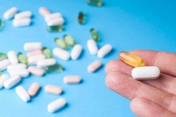 istock Medicine pills or capsules in hand 614980428