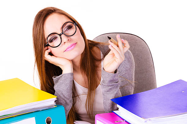 istock Woman sitting at desk in office and thinking 614981258