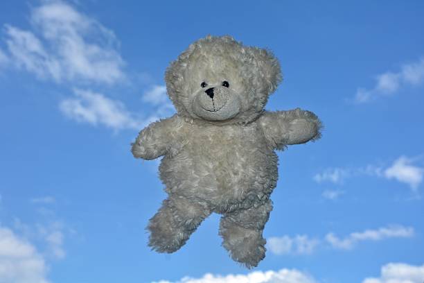 girl playing with teddy bear
