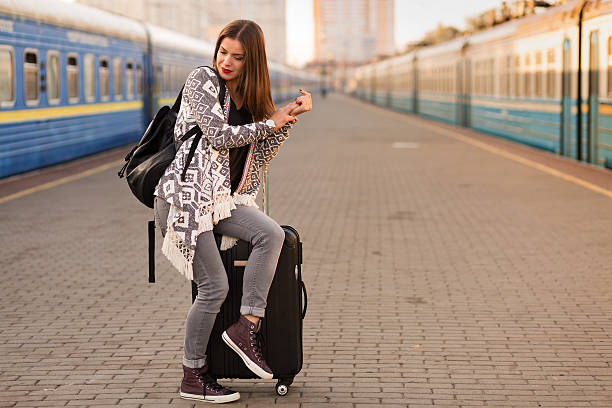 istock Beautiful woman at the train station 614982254