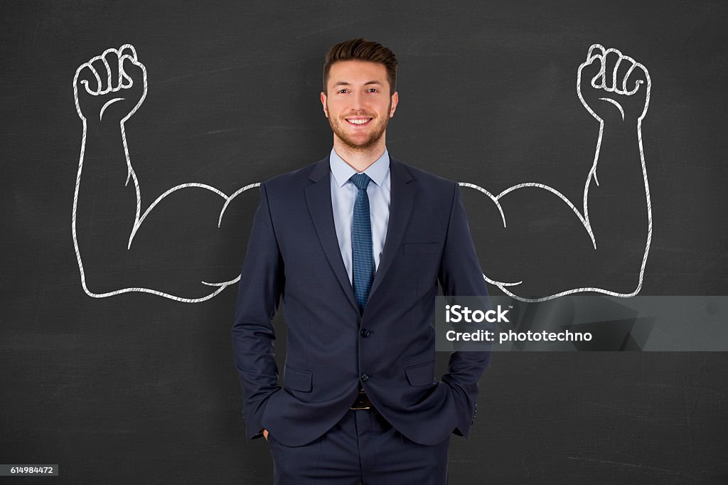 Successful business man on blackboard Strength Stock Photo