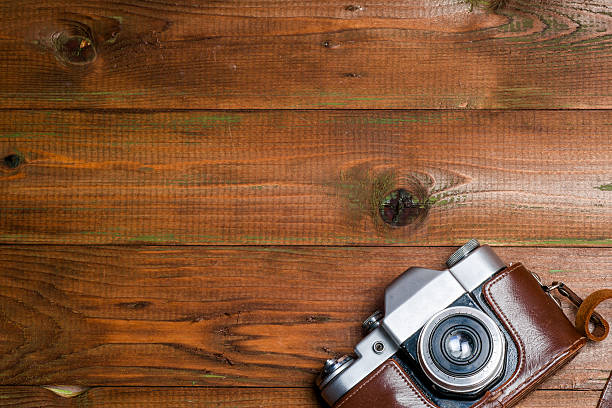 istock Old retro camera on vintage wooden boards abstract background. 614985006