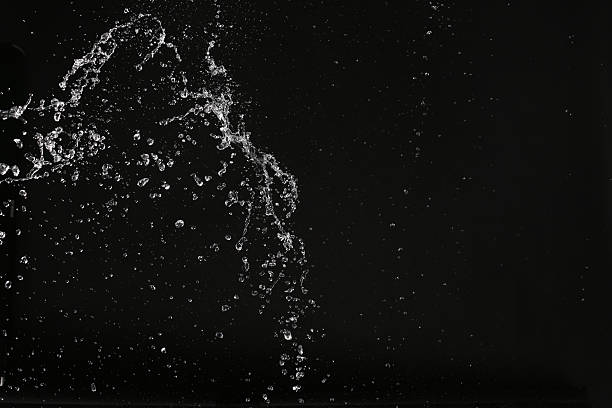 istock White splash of water in space. Close up. Black background 614985850