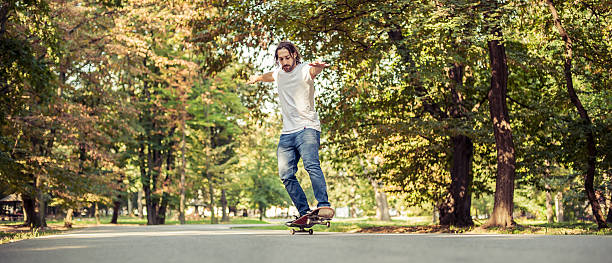 istock Skateboarder riding a skateboard on the two wheels 614985872