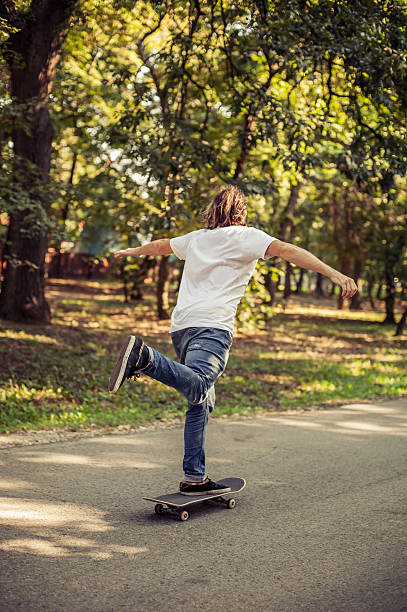 istock Skateboarder riding a slope through the forest 614985992