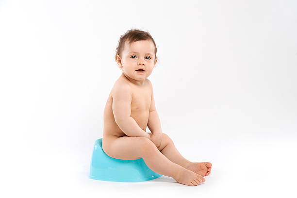 child sitting on the potty baby smiling and sitting on the potty accustom stock pictures, royalty-free photos & images