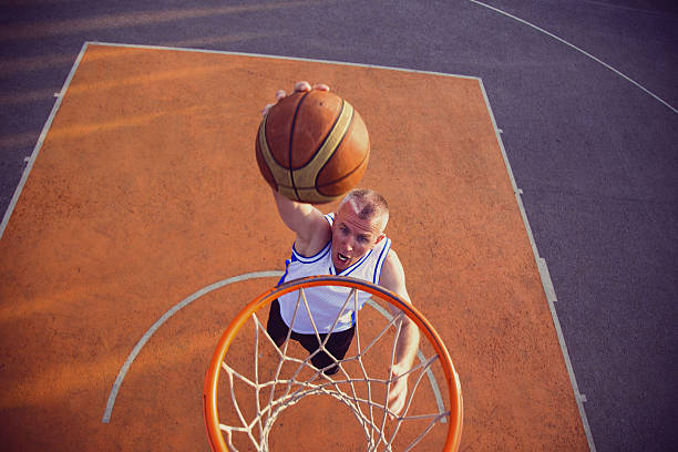 istock Basketball street player making a slam dunk 614987706