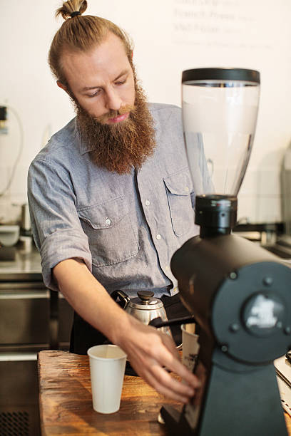 istock Young barista preparing coffee at restaurant 614988212