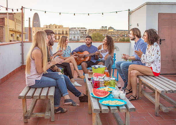 istock Friends playing guitar on rooftop 614988234