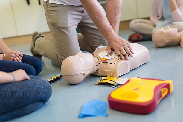 First aid resuscitation course using AED. First aid cardiopulmonary resuscitation course using automated external defibrillator device, AED. rescue services occupation stock pictures, royalty-free photos & images