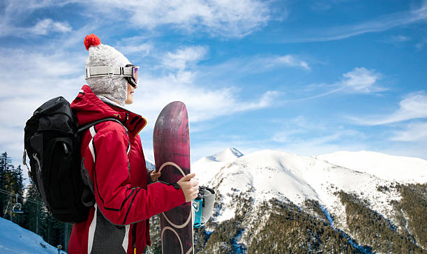 istock Girl standing with snowboard 614989524