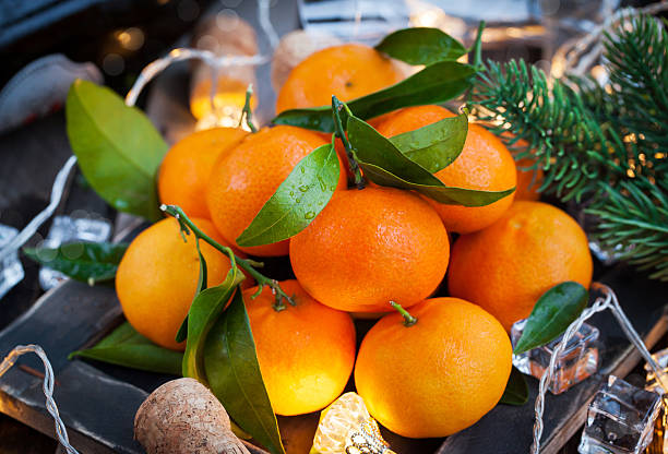 istock Fresh tangerines on holiday background 614989578