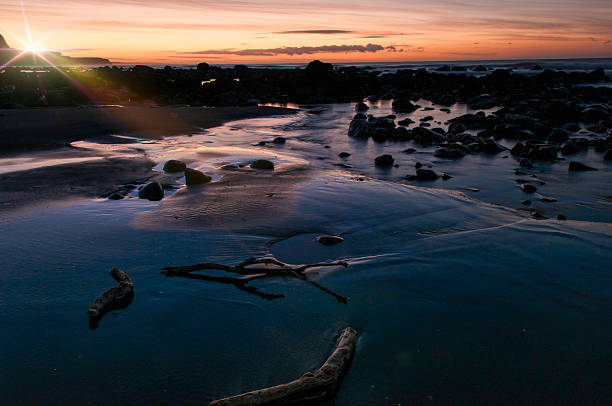 istock Rocky beach with flare 614990658