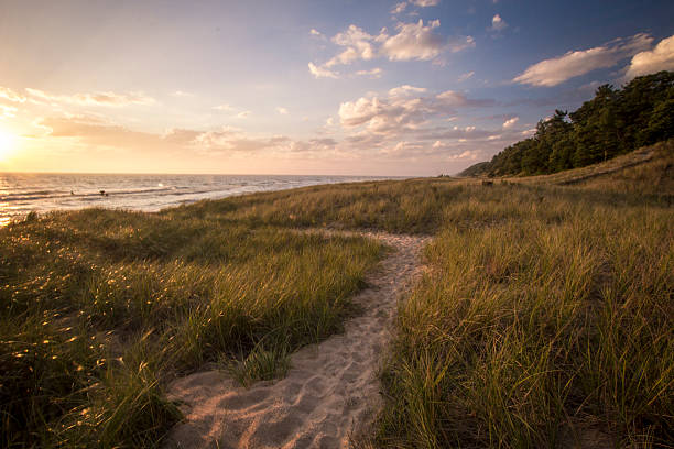 Winding path through dune grass and sand dunes on the shores of Lake Michigan. Hoffmaster State Park, Michigan