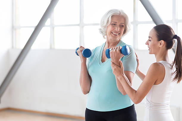 istock Cheerful persistent woman holding dumbbells 614991820