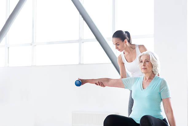 istock Serious hard working woman exercising with a dumbbell 614991994