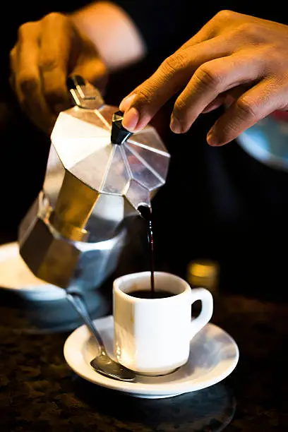 Photo of Cuban strong coffee pouring from moka pot