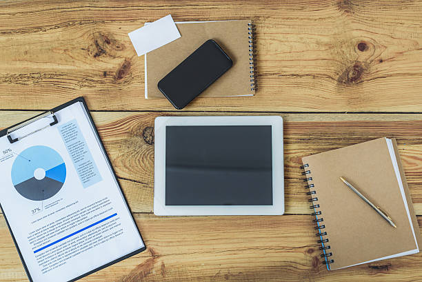 istock Wooden office desk with digital gadgets 614994900