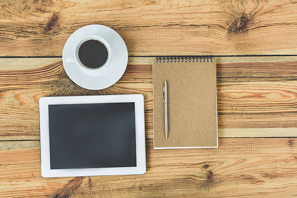 istock Wooden office desk with digital tablet 614994992