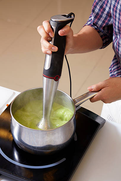 Hand use food blender for making pea soup