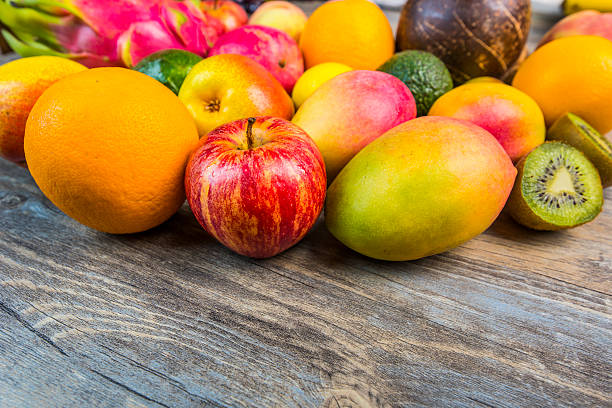 istock fruits on wooden background 614997716