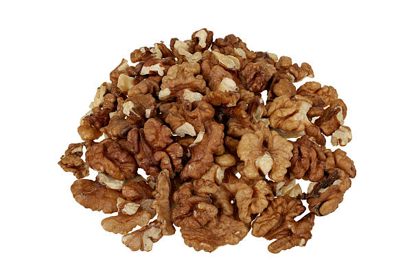 Pile of peeled walnuts isolated on white background stock photo