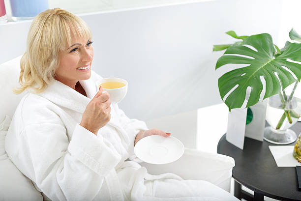 istock Joyful senior lady relaxing at spa 615072546