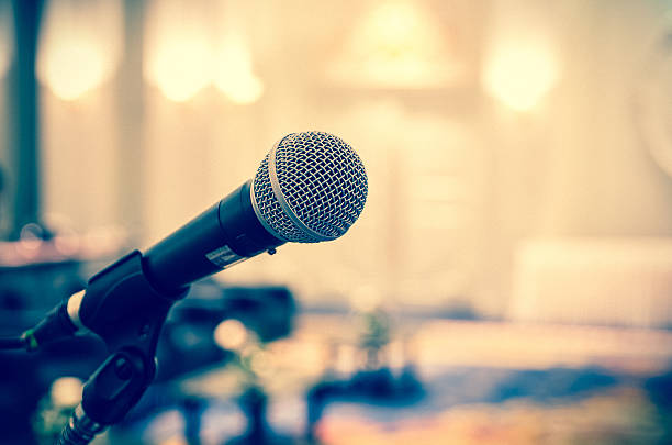 istock Microphone over the Abstract blurred photo of conference hall 615072688