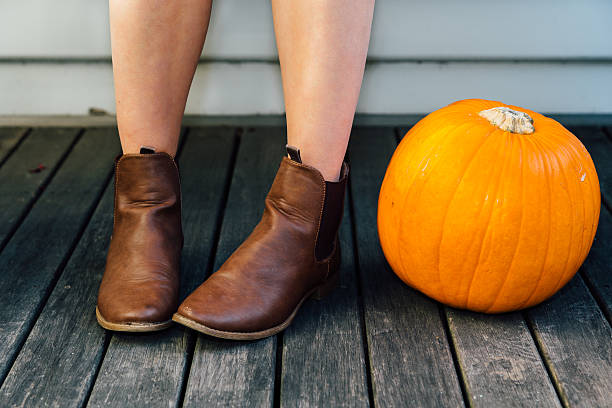 istock Young woman with pumpkin 615073846