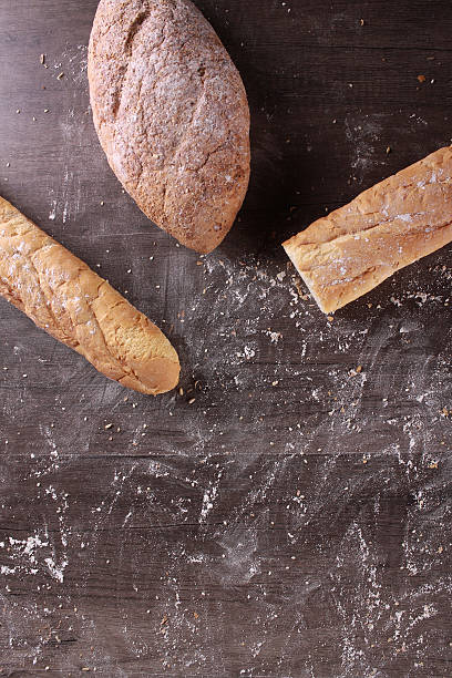 istock wheat bread isolated on wooden background 615076556