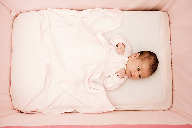 istock Newborn baby in crib 615076608