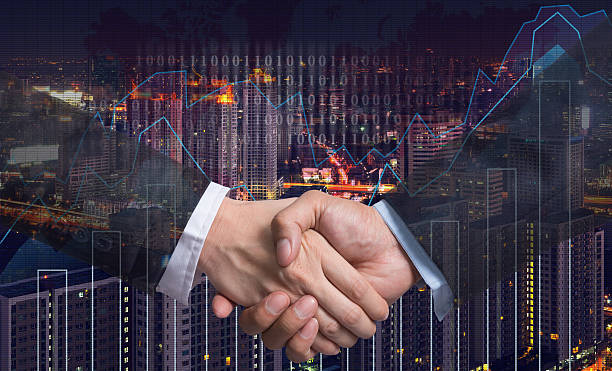istock Hand shake between businessman on Trading graph on the cityscape 615077562