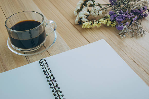 istock Put blank notebook near glass of hot coffee 615078448