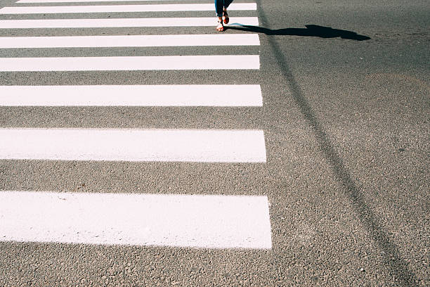 istock Pedestrian zebra with walking legs and asphalt 615078654
