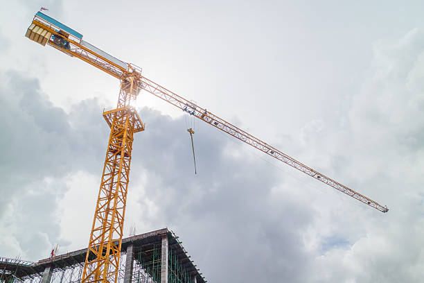 istock Tower crane on a construction site against dark sky 615079120