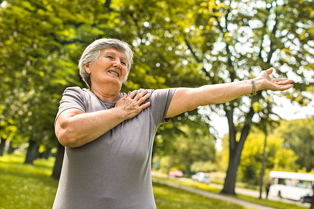 istock Happy old woman doing relaxation exercises in the park. 615080762