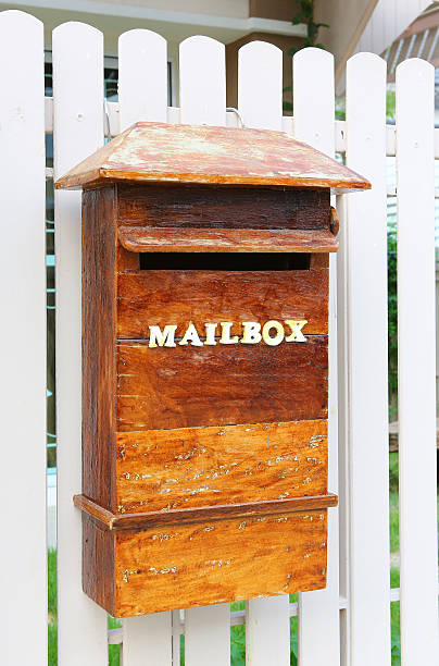 istock Wood mailbox against white fence 615081770