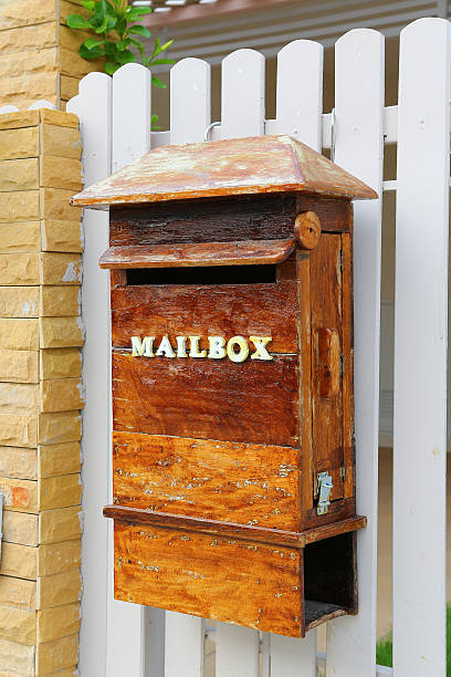 istock Wood mailbox against white fence 615081896