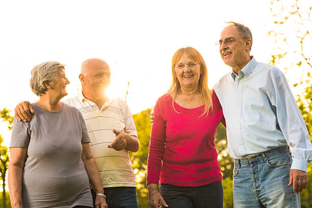 istock Embraced senior couples taking a walk in the park. 615082658