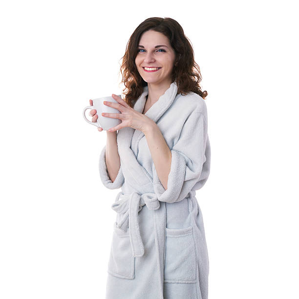istock Young woman in bath robe over white isolated background 615083762