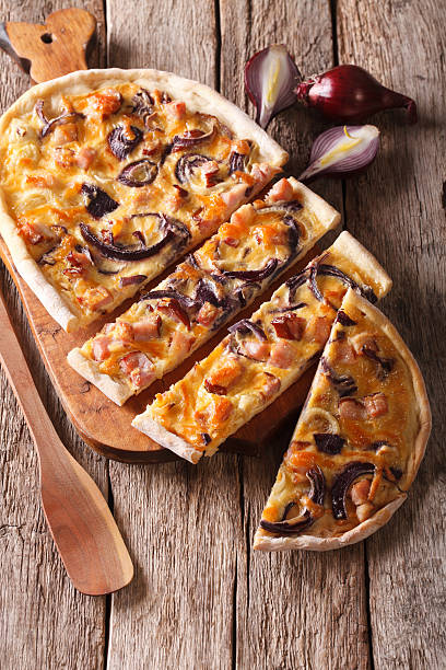 istock Delicious sliced pie flammkuchen close-up on the table. Vertical 615083848