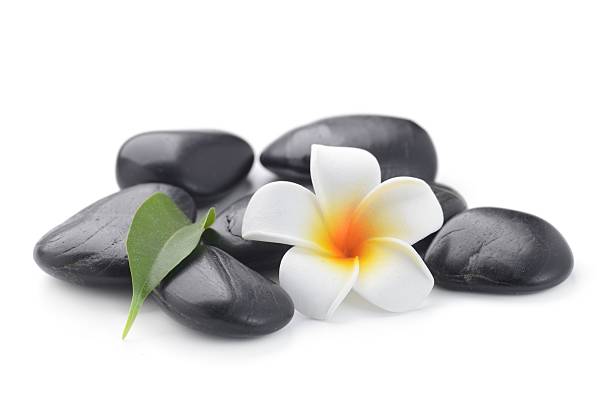 istock zen basalt stones and frangipani 615084596