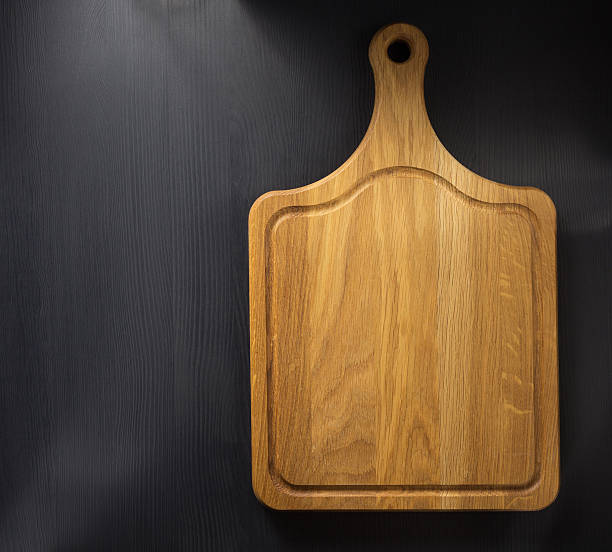 istock cutting board at wooden table 615087560