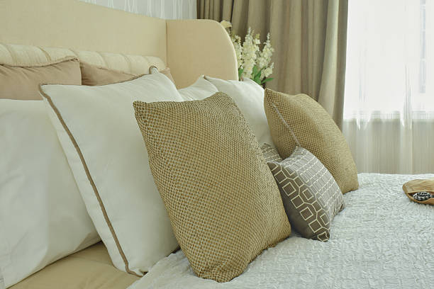 istock Modern classic bedding with brown, beige and light brown pillows 615087578