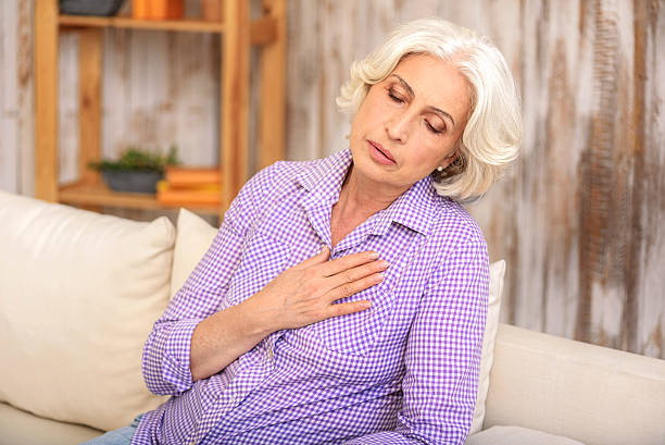istock Desperate senior lady has pain in heart 615088068