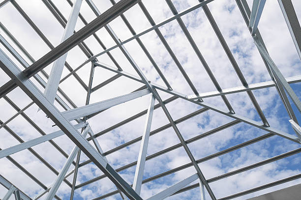 istock Structure of steel roof frame with blue sky and clouds 615088366